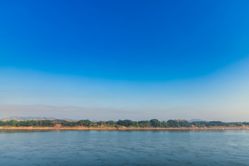 Fototapeta na wymiar Beautiful early morning sunrise air atmosphere bright blue sky background abstract clear texture with white cloud of Mae Khong river