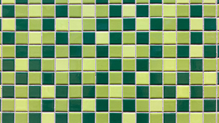 Closeup green tiles checkered wall. 