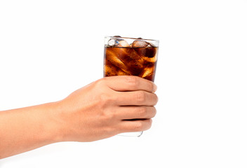 Hand holding a glass of cola with ice on white background