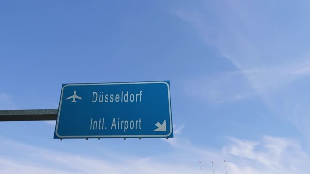 dusseldorf airport sign airplane passing overhead germany