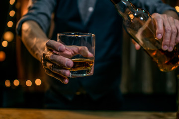 Whisky is poured into glass Beautiful bokeh