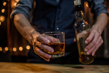 Barman pouring whiskey whiskey glass
