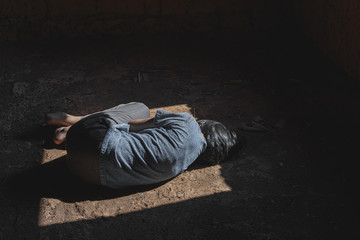 human trafficking concept, Helpless girl lying on floor old room,children violence and abused concept,