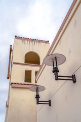 Fototapeta na wymiar Two electric lamps on a church wall
