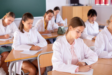 Fototapeta premium Medical students writing in notepads