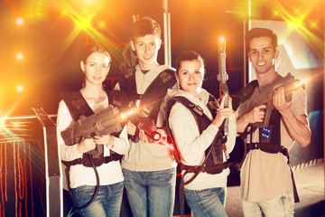 Adult people posing with laser guns