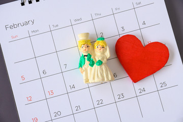 Miniature married couple on the calendar. concept for wedding & valentine Day.