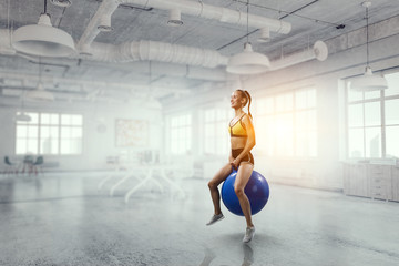 Obraz premium Sporty woman on fitness ball. Mixed media