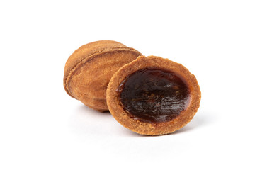 Shortbread in shape nut with caramel isolated on white background.