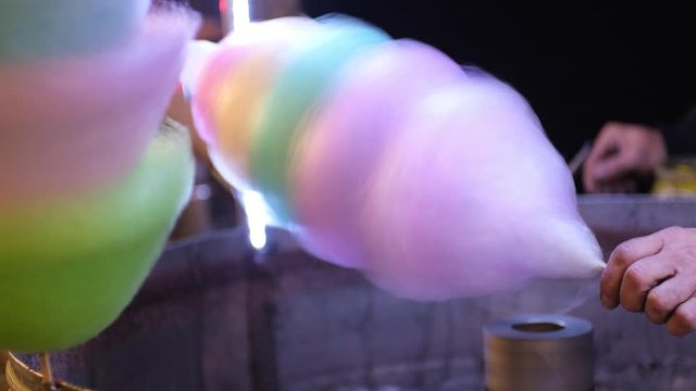 Making of cotton candy on festival. Street food. Dessert