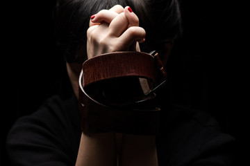 Woman tied up with leather belt in emotional stress and pain