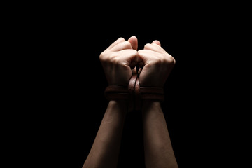 Woman tied up with leather belt in emotional stress and pain