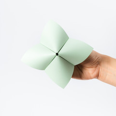 Hand in a paper fortune teller isolated on white background.