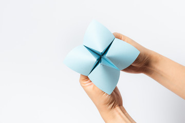 Hand in a paper fortune teller isolated on white background.