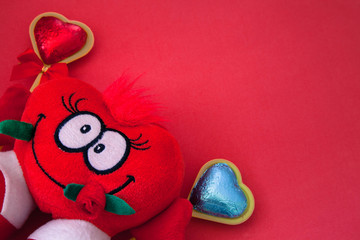 soft toy in the shape of a heart with candy heart,copy space 