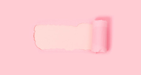 Top view of pink torn paper on white background.