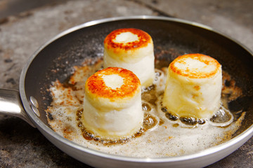 three lush toasted cheesecakes, fried in a pan, in butter, cooking