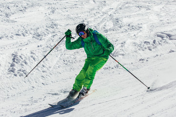 Skier in mountains. Professional skier athlete skiing of ski resort.Winter vacation and sport concept.