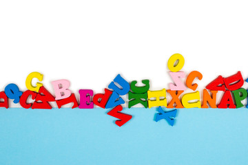Row of multicolored letters isolated on a white background. Copy space.