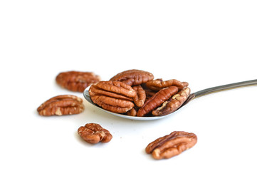 Pecan in a spoon on white background - isolated