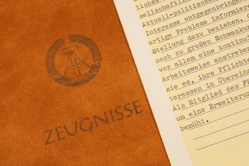 Education in the communist government German Democratic Republic East Germany. leather School report book cover with GDR Logo and german word Zeugnisse, School report. card with an political Appraisal