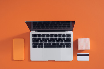 Online shopping concept desktop with computer, table, shopping bags, credit cards, coupons and products