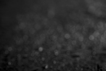 Abstract background white bokeh dispersion on a black background. background black abstract bokeh for Christmas night light holiday