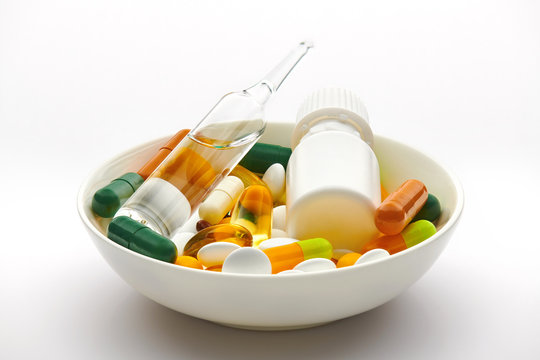 Plate with set of pills, tablets, vitamins, drugs, omega 3 fish oil, gel capsules, medicament and food supplement for health care. Pharmaceutical industry. Pharmacy.