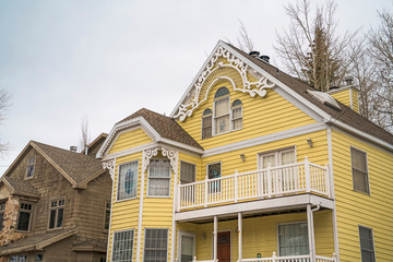 Home in Park City with pastel yellow wall and balconies with white railings