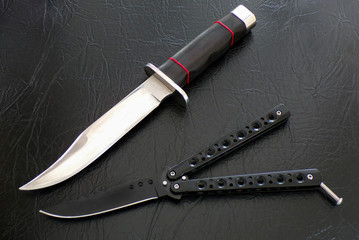 Knives close-up. Weapons for murderers and maniacs. Knives on a background of black leather....