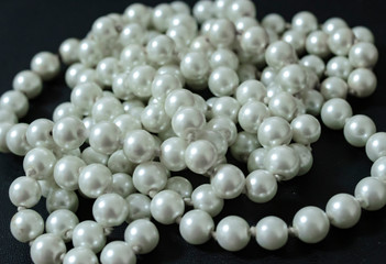 pearl jewelry on a black photo