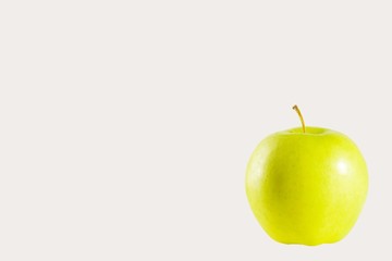 green ripe juicy Apple on a white background isolated