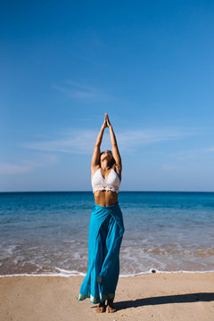 urdhva hastasana on the beach early morning near the sea