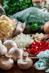 Fototapeta na wymiar Ingredients ready for prepare tagliatelle pasta with champignon