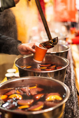 Hot mulled wine at the christmas market. Steam over cauldrons with hot wine. Street food. Outdoors....