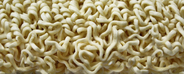 Dry instant noodles on white.