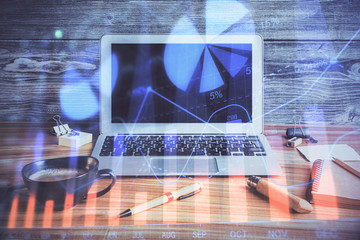 Double exposure of graph and financial info and work space with computer background. Concept of...