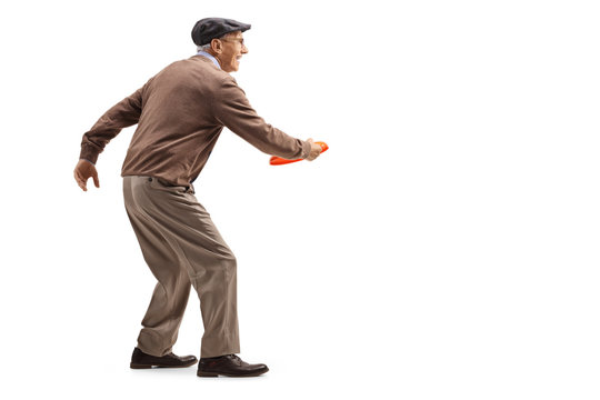 Elderly gentleman playing a game with throwing a plastic disk