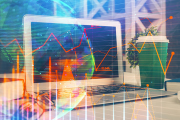 Financial graph colorful drawing and table with computer on background. Double exposure. Concept of...