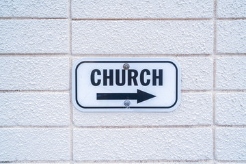 Church sign with arrow pointing to the right