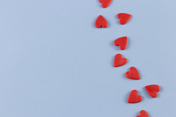 red hearts on a blue background with room for text