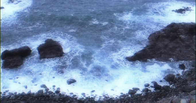 rocks with storm surge in vhs errors and glitches. video tape damaged with sea and coast and waves with foam. sea and ocean with noise lines and false colors
