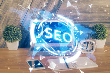 Multi exposure of table with computer and seo drawing hologram. Search optimization concept.
