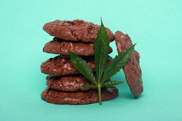 glazed cookies with peanuts and cannabis, recreational drug marijuana cookies on red background.