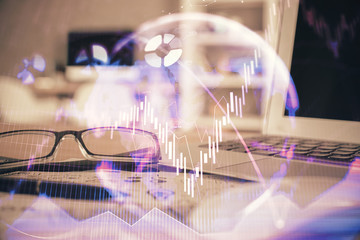 Financial chart hologram with glasses on the table background. Concept of business. Double exposure.