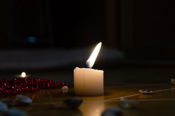 pentagram is painted on the floor, candles are lit, beads are lying, shells are scattered. concept...