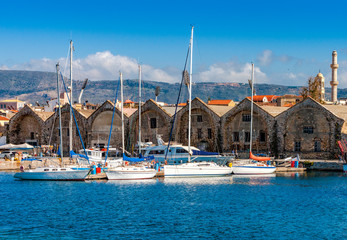 Fototapeta na wymiar Yachts and boats moored near the Venetian Neoria, Chania, Crete, Greece.
