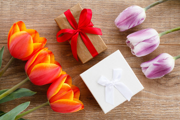 Gift boxes with ribbons on wooden boards.