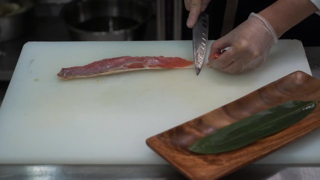 Cook slices fish