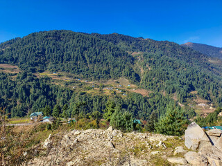 Fototapeta na wymiar NEPAL, OCTOBER 29, 2019: On the trekking way from Phaplu (Salleri) to Taksindu La Pass, Himalayas, Nepal. Everest base Camp trek. View on local nepalese village houses (lodges).